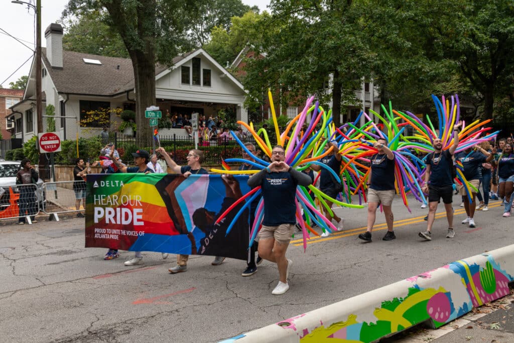 Delta Airlines employees marching in Atlanta Pride parade on 10th Street in Midtown